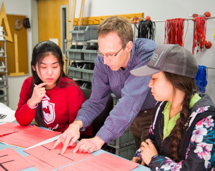 Photo of students and teacher. Link to Gifts from Retirement Plans