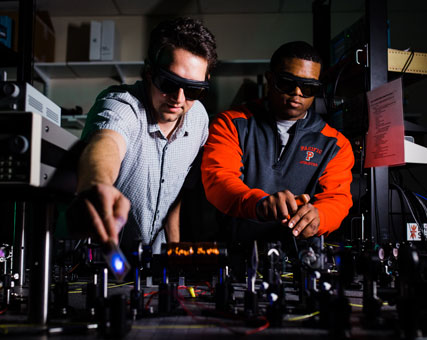 Photo of two men working. Link to Gifts of Life Insurance